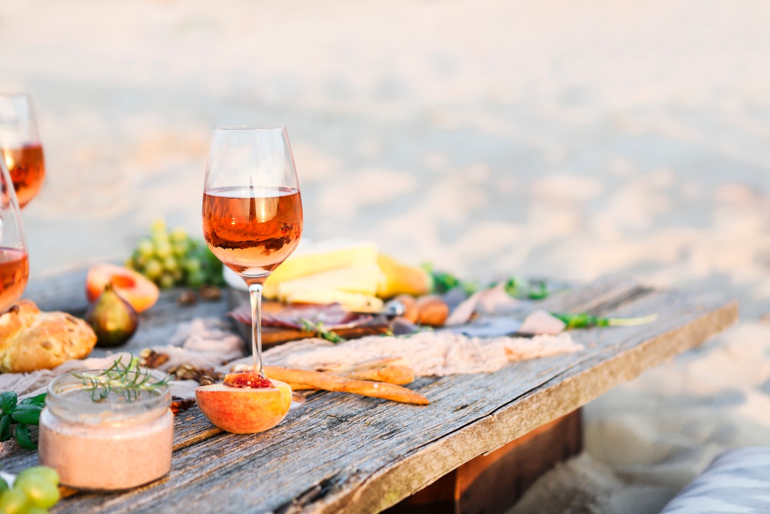 Glass of rose wine on rustic table. Food and drink background