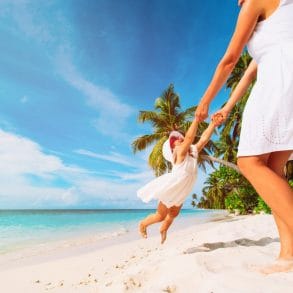 mother and daugher playing during a vacation to the cayman islands with kids