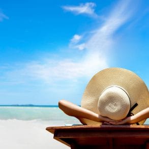 woman enjoying best time to visit the Cayman Islands on the beach