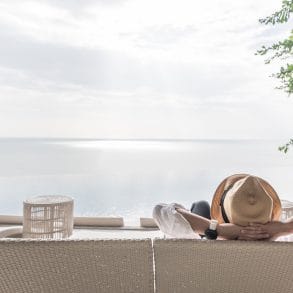 Relaxation holiday vacation of businessman take it easy happily resting on beach chair at swimming pool poolside beachfront resort hotel with sea or ocean view and summer sunny sky outdoor