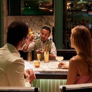 two models enjoying cocktails at silver palm