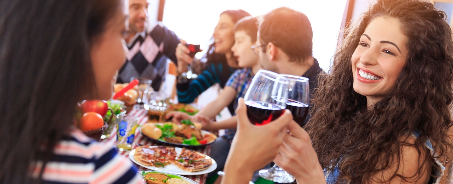 People feasting and drinking wine outdoors