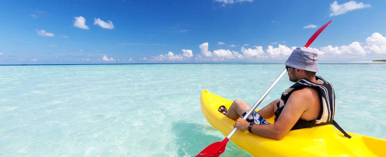 man kayaking in grand cayman on a sunny day