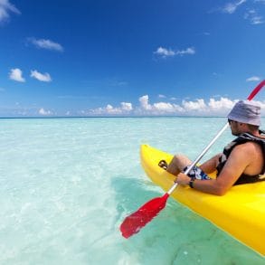 man kayaking in grand cayman on a sunny day