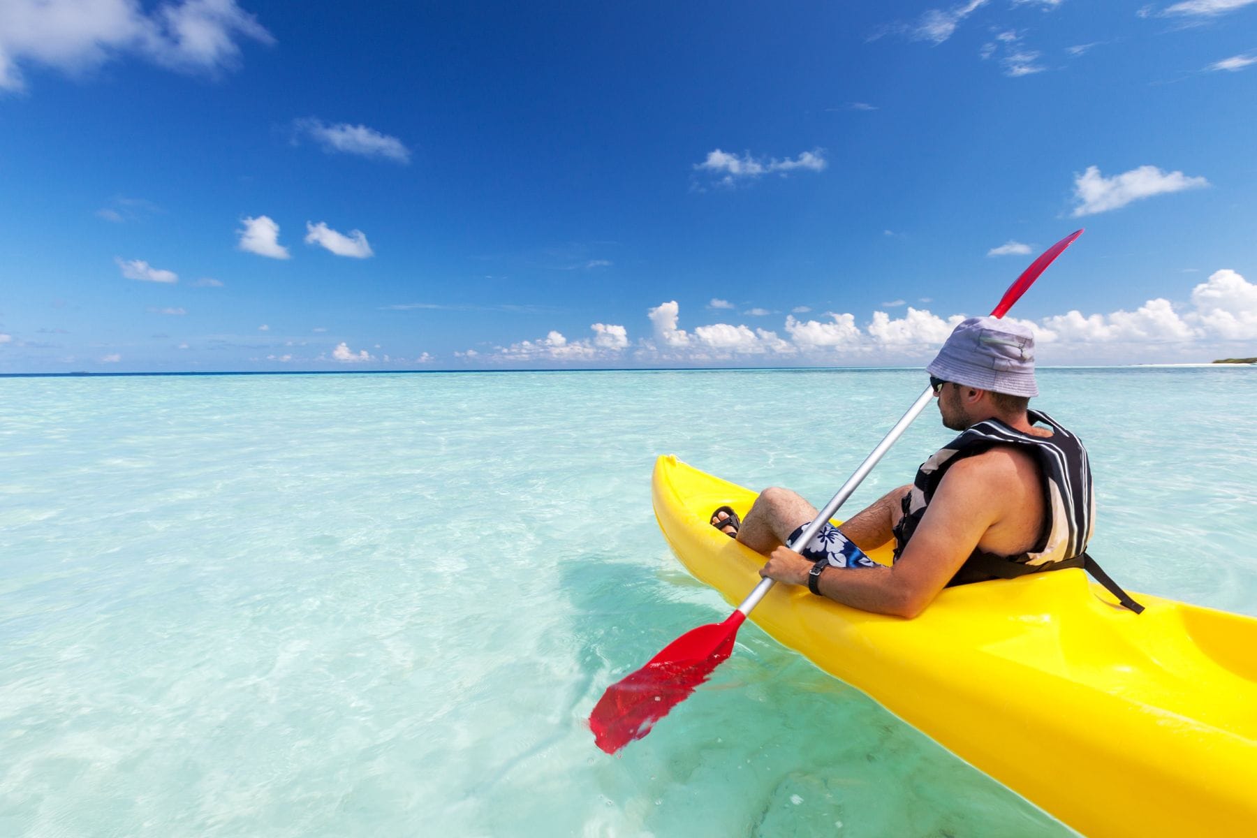 man kayaking in grand cayman on a sunny day