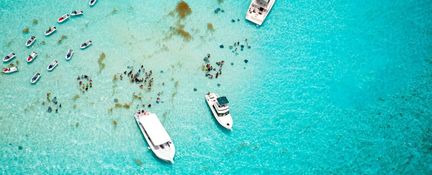 aerial view of stingray city in grand cayman with boats and jet skis