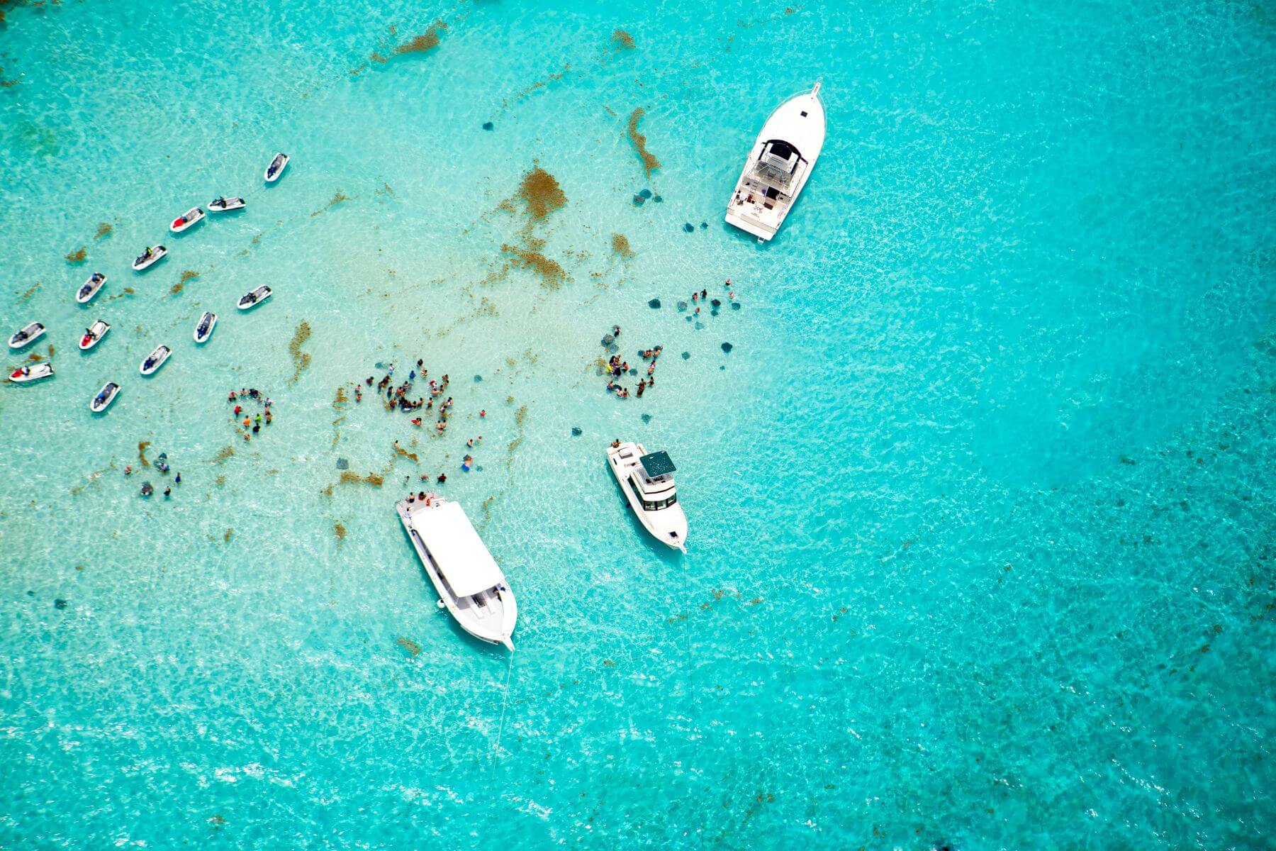 aerial view of stingray city in grand cayman with boats and jet skis